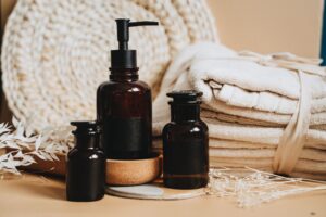 Elegant display of toiletry products featuring pump bottles, towels, and natural accents.